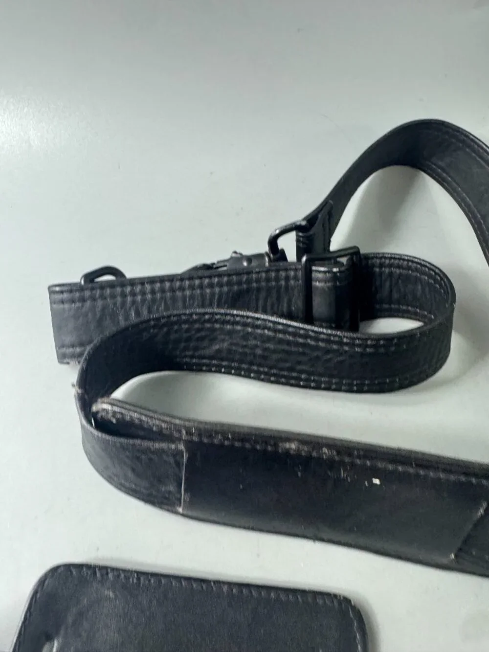 A Bundle of Two (2) Vintage Tumi Black Leather Strap and Travel Tag